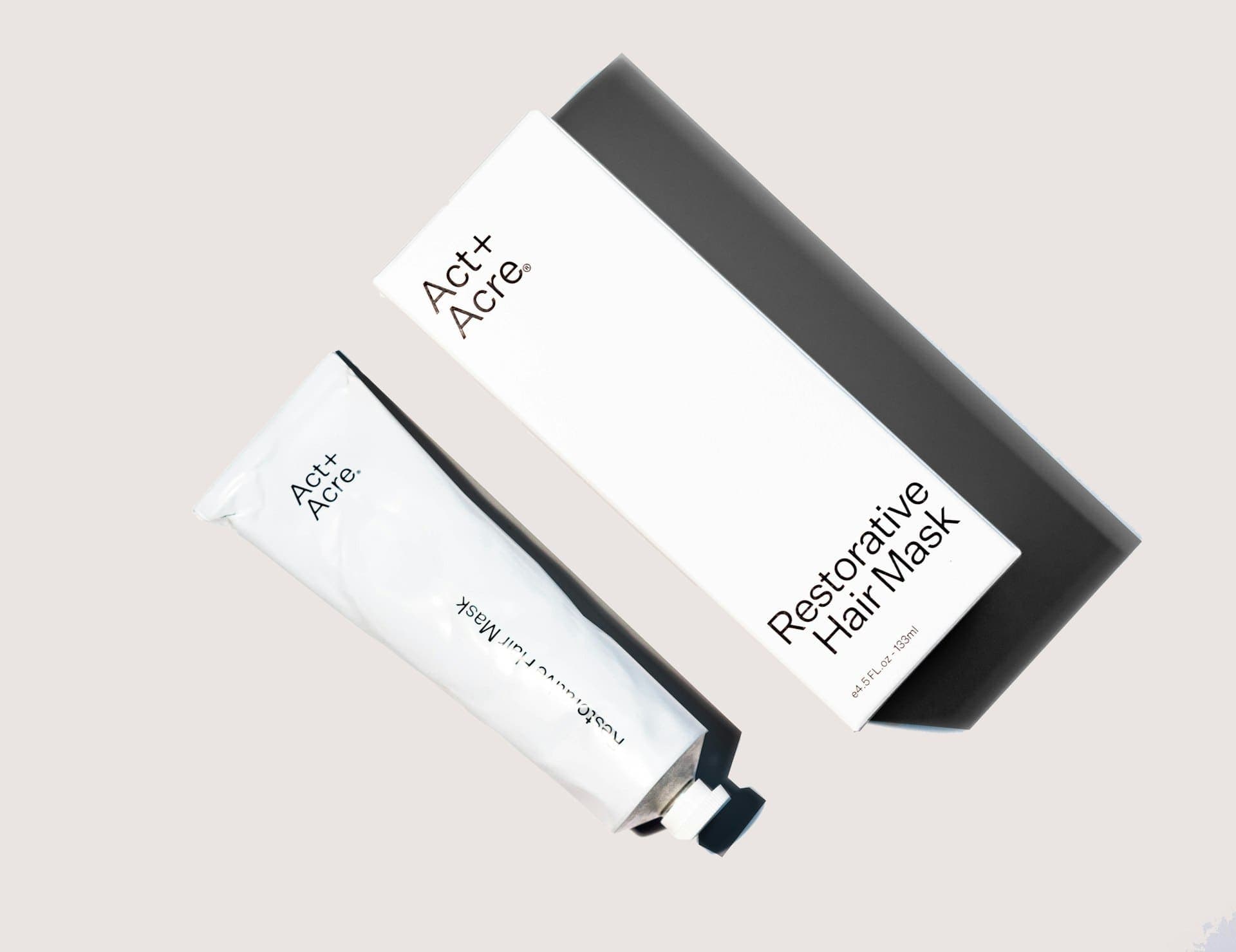 Clear glass skincare bottles in soft daylight
